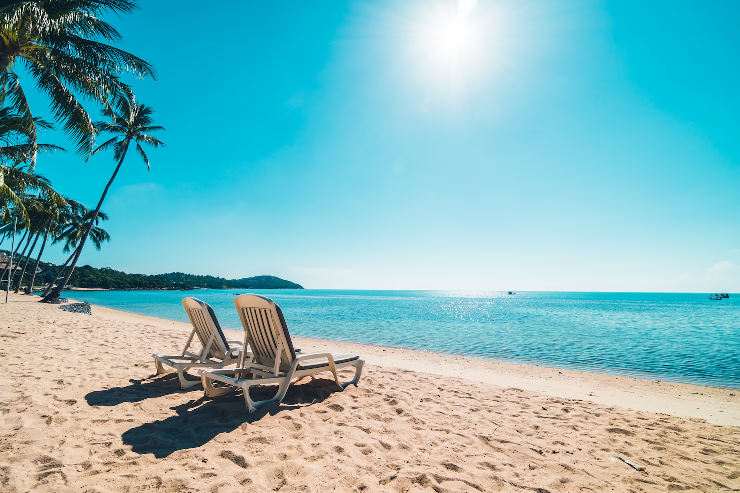 Sunny beach with lounge chairs